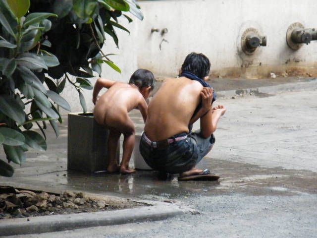 Asian helps man shower
